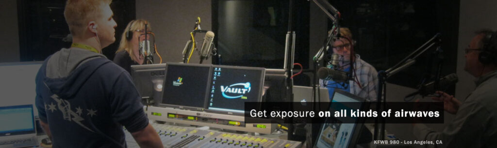 Radio hosts engaging in a live broadcast at KFWB 980 in Los Angeles, surrounded by studio equipment. Highlights the dynamic environment of radio production.