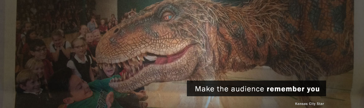 A lifelike dinosaur exhibit captivates a group of excited children, with one child interacting closely as others watch in awe.