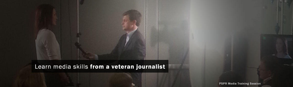 Media training session featuring a veteran journalist conducting an interview with a participant, emphasizing skill development in journalism.